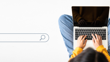 A woman searching for information on a laptop